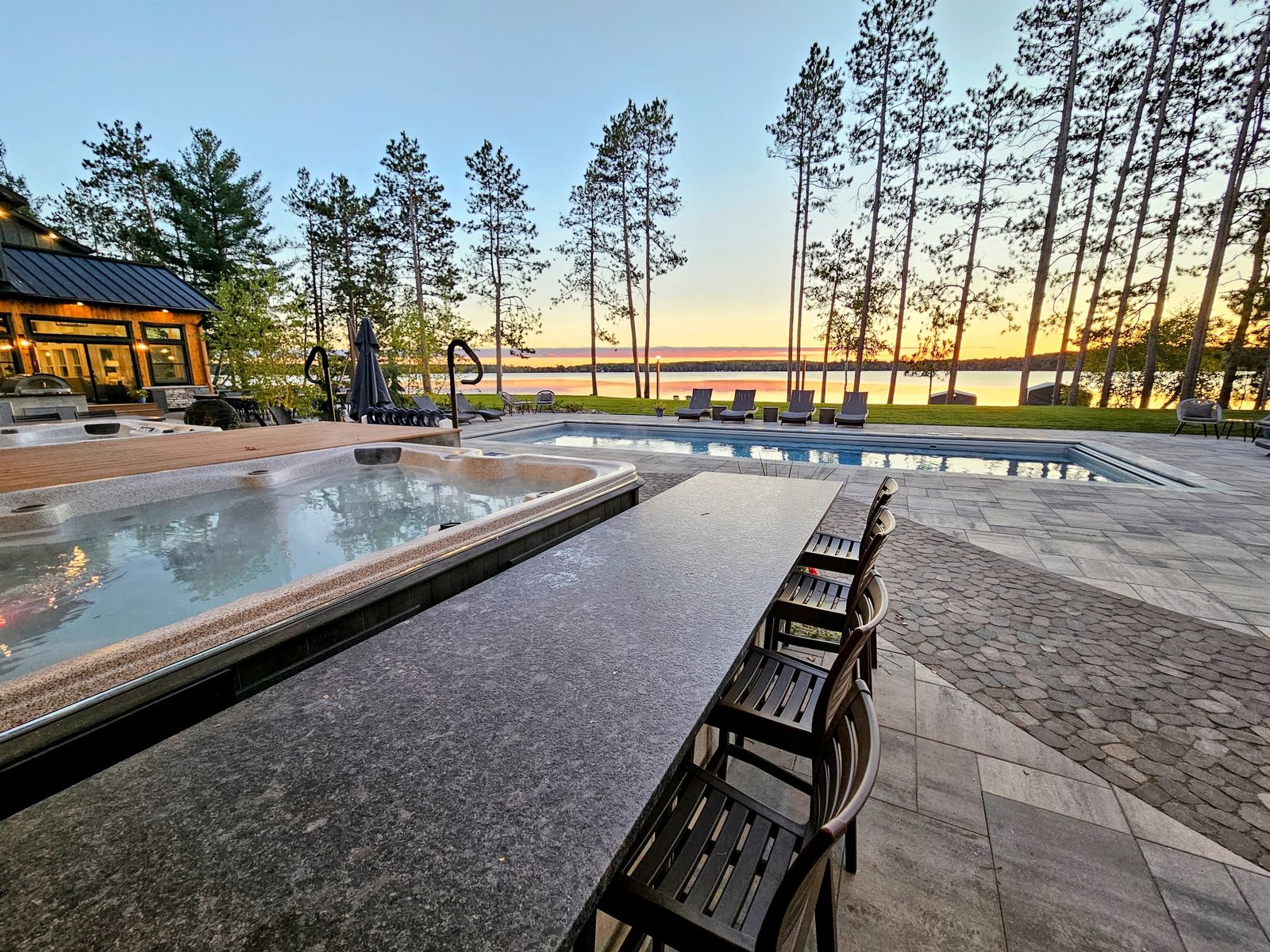Heated pool and patio overlooking Spooner Lake