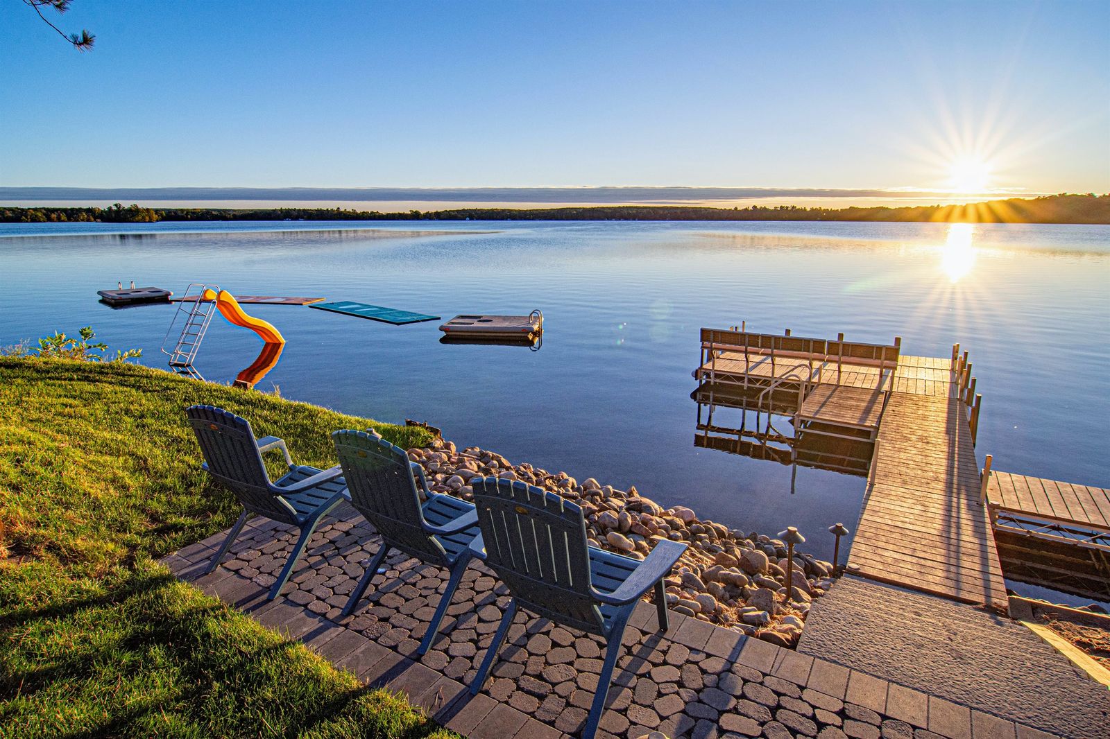 Dock and shoreline chairs at sunset